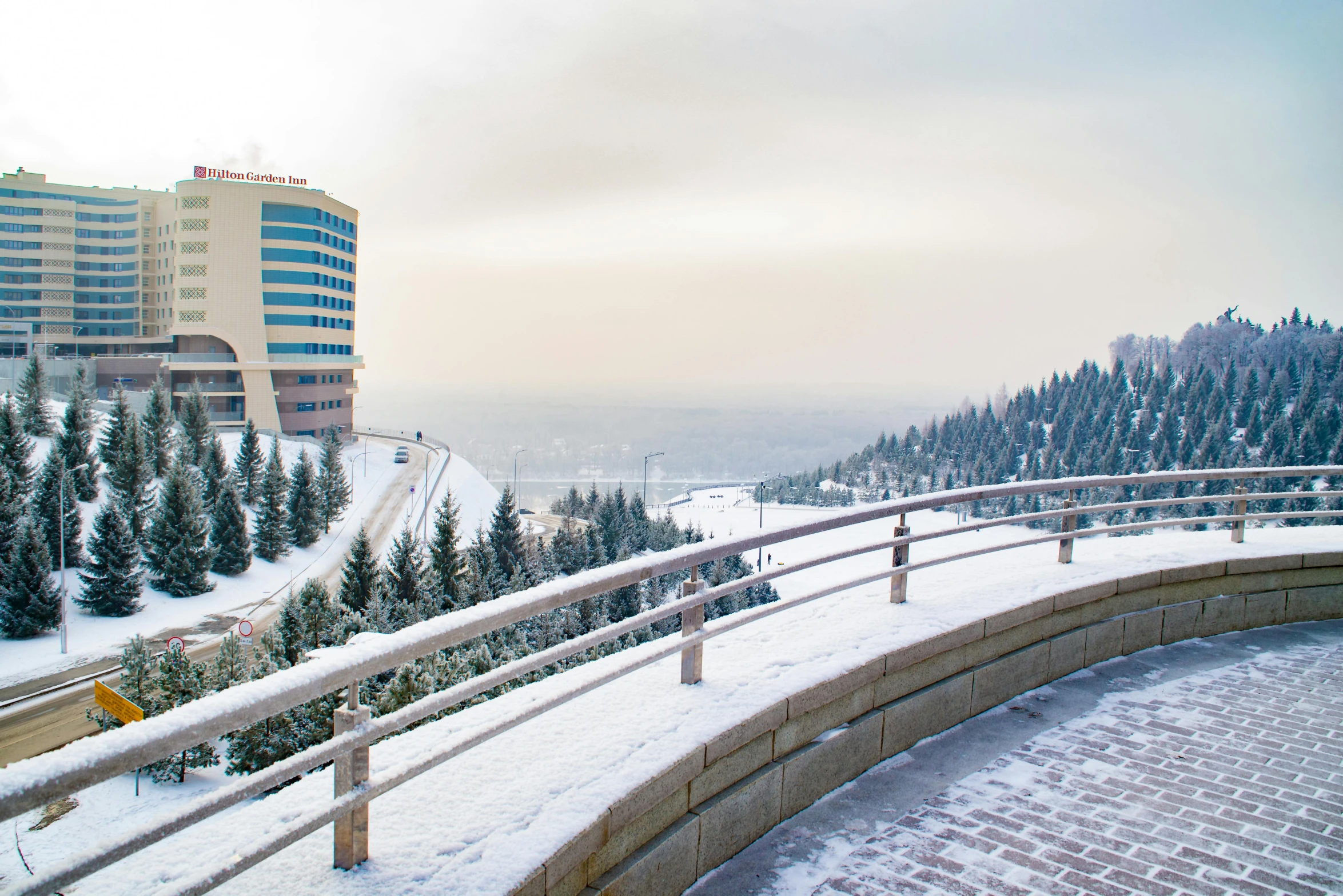 a man riding a snowboard down a snow covered slope, by Emma Andijewska, pexels contest winner, art nouveau, soviet architecture, panorama view, medical complex, 000 — википедия