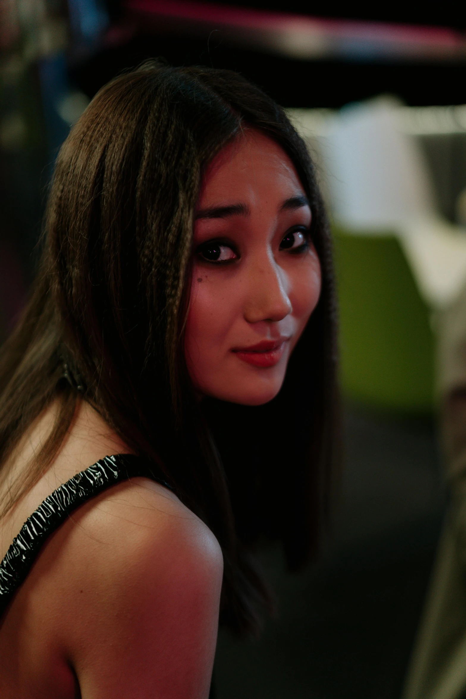 a close up of a person wearing a dress, inspired by Feng Zhu, reddit, hyperrealism, looking distracted and awkward, in a movie still cinematic, she is wearing a black tank top, asian girl with long hair