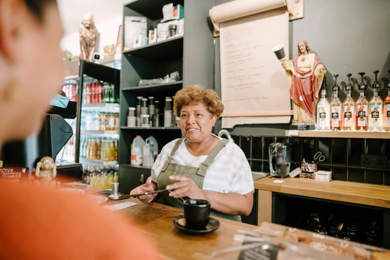 a woman sitting at a counter in a coffee shop, pexels contest winner, renaissance, old lady cyborg merchant, aussie baristas, thumbnail, saint womans