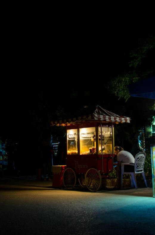 a food cart sitting on the side of a road at night, a portrait, flickr, on jungle night !!!, cafe, square, afternoon time
