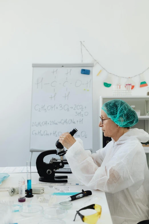 a woman in a lab coat using a microscope, trending on unsplash, photo of a classroom, white wall coloured workshop, made of lab tissue, high quality photo