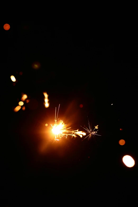 a close up of a sparkler in the dark, pexels, light and space, photographed for reuters, ilustration, broken lights, happy birthday