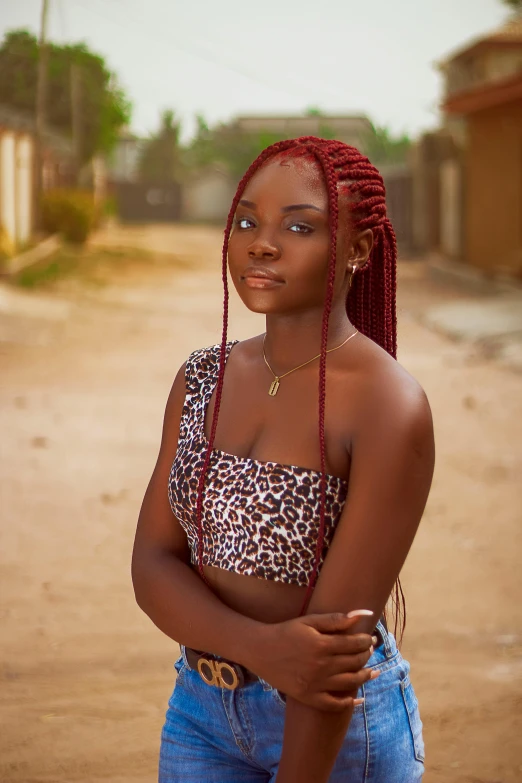 a woman standing in the middle of a dirt road, an album cover, by Chinwe Chukwuogo-Roy, trending on pexels, realism, red braided hair, teenager girl, maroon red, headshot profile picture