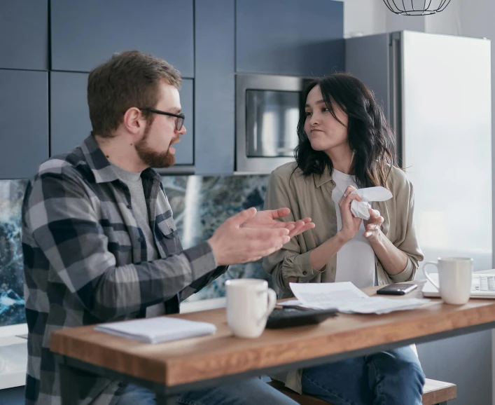 a man and a woman sitting at a kitchen table, convincing, whealan, settlement, toggling