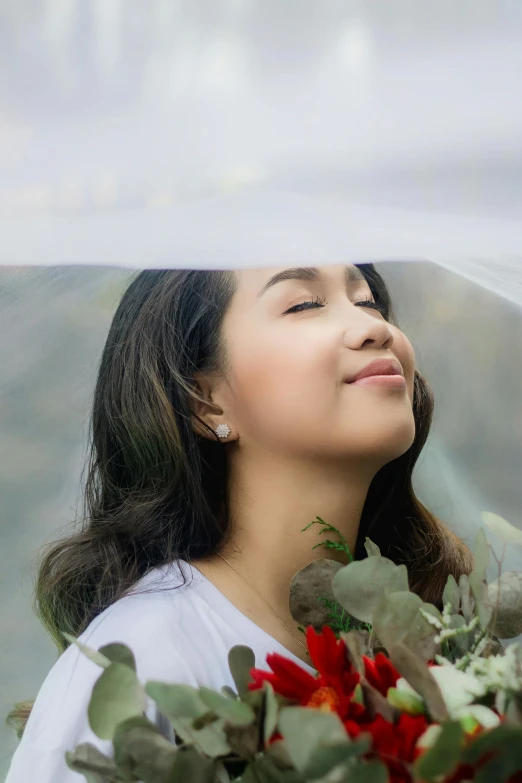 a woman holding a bouquet of flowers under a veil, inspired by Ruth Jên, pexels contest winner, smiling young woman, dreaming face, lush scenery, looking upwards