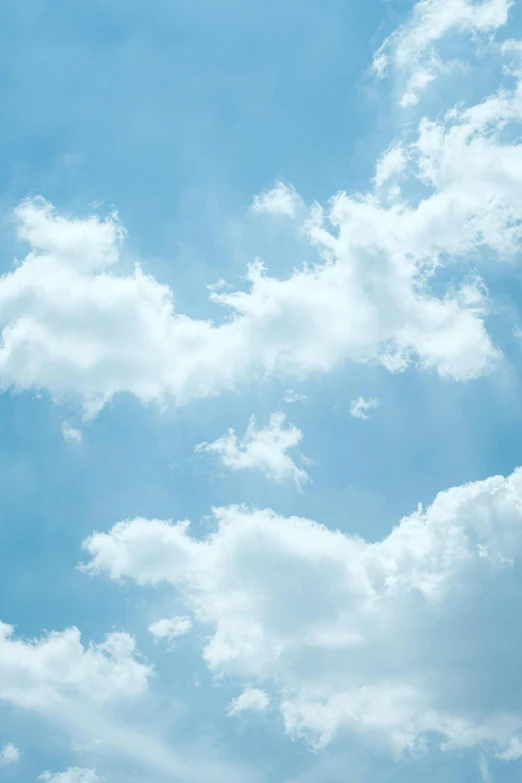 a plane flying through a cloudy blue sky, by Carey Morris, romanticism, close - up photograph, illustration, cumulus, high quality image