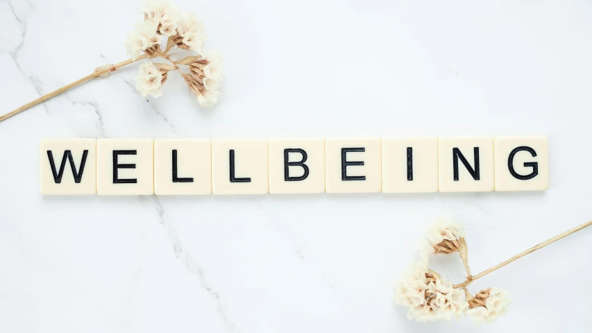 the word well being spelled in scrabbles on a marble surface, by Helen Biggar, trending on pexels, aestheticism, on a pale background, background image, overlord billie eilish, folds of belly flab