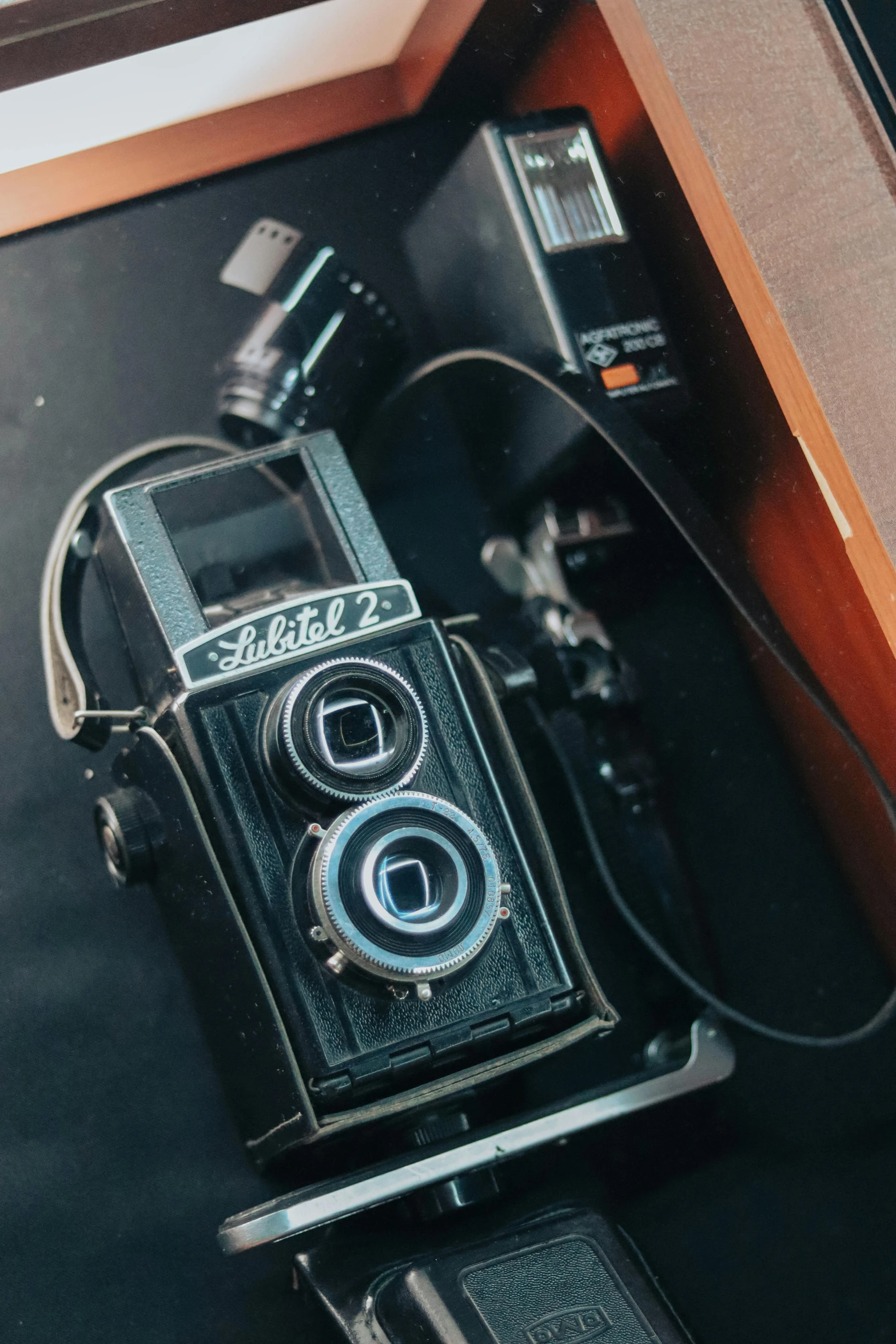 an old camera sitting on top of a table, style of ade santora, sharp focus w - 9 6 0, medium-shot, color photo