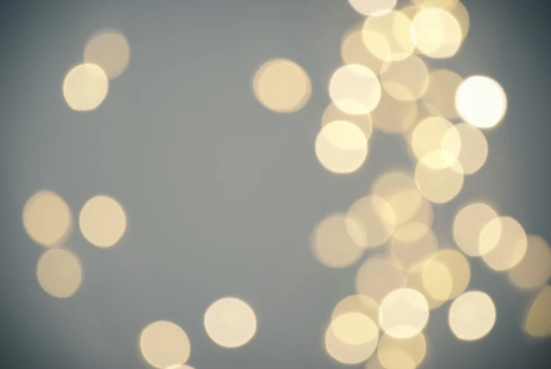 a close up of a bunch of lights, pexels, light and space, grey and gold color palette, blurry footage, soft white glow, clean render