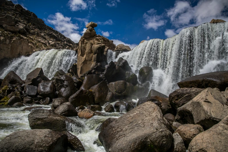 a waterfall in the middle of a rocky area, by Bertram Brooker, pexels contest winner, hurufiyya, ivan bolivian, thumbnail, festivals, mongolia