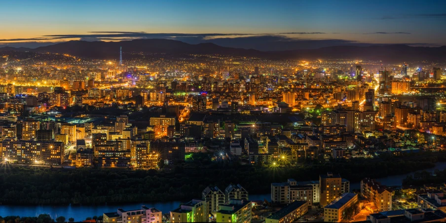 an aerial view of a city at night, by Adam Marczyński, pexels contest winner, mongolia, panorama view, summer evening, print ready