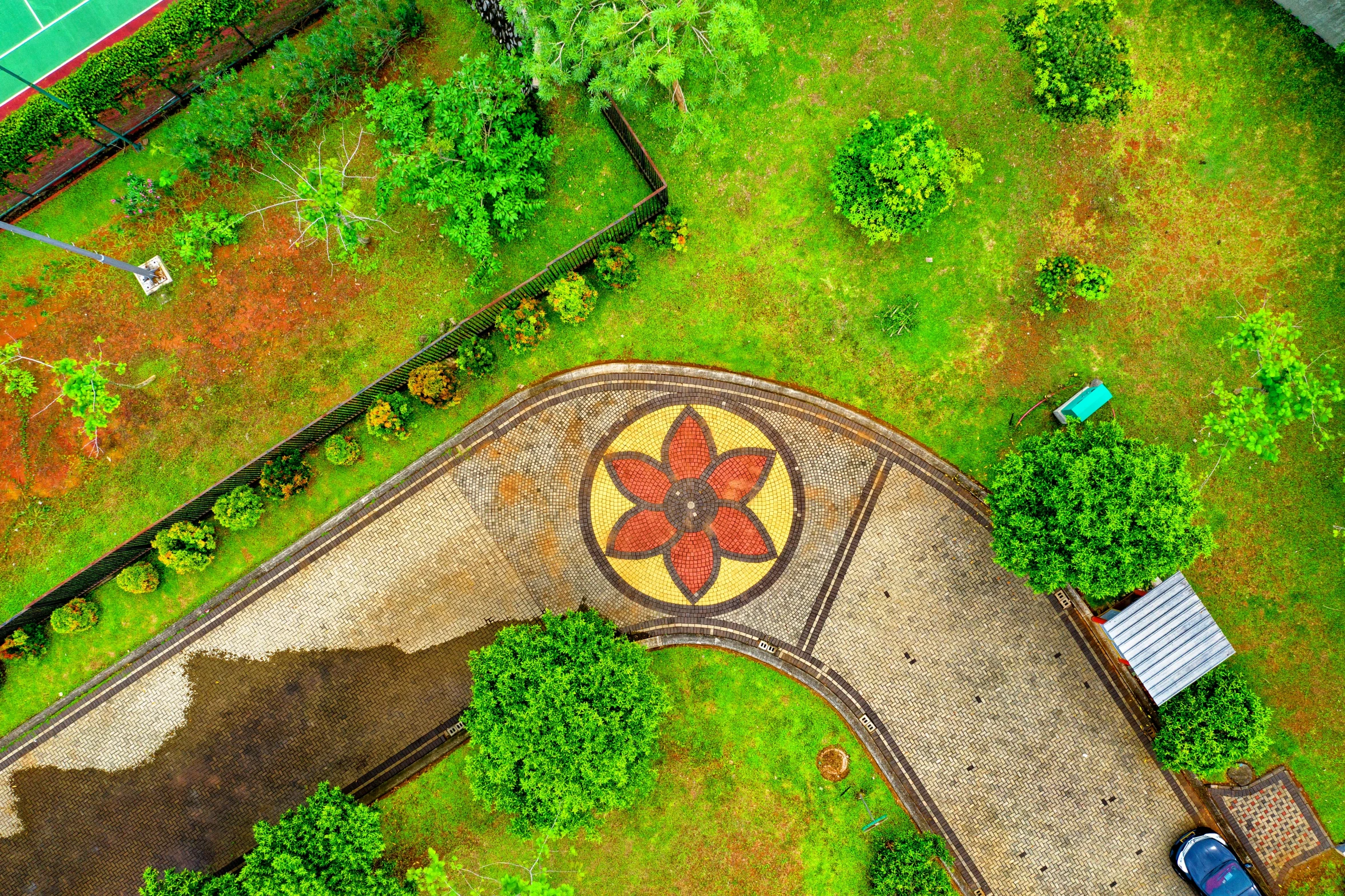 an aerial view of a tennis court surrounded by trees, a mosaic, by Dan Content, pexels contest winner, land art, depicting a flower, shipibo, avatar image, pathway