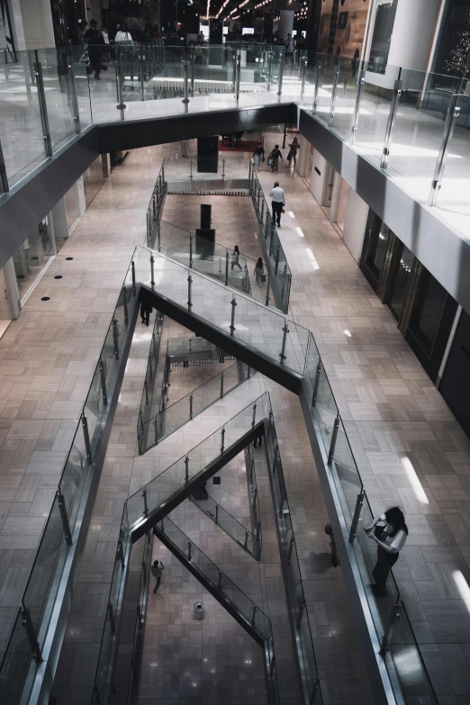 a couple of escalators that are inside of a building, an album cover, inspired by Andreas Gursky, trending on unsplash, modernism, southdale center, big open floor 8 k, high angle shot, reddit post