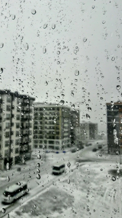 a view of a city through a rainy window, by Ryan Pancoast, heavy snow fall, 8k octan photo