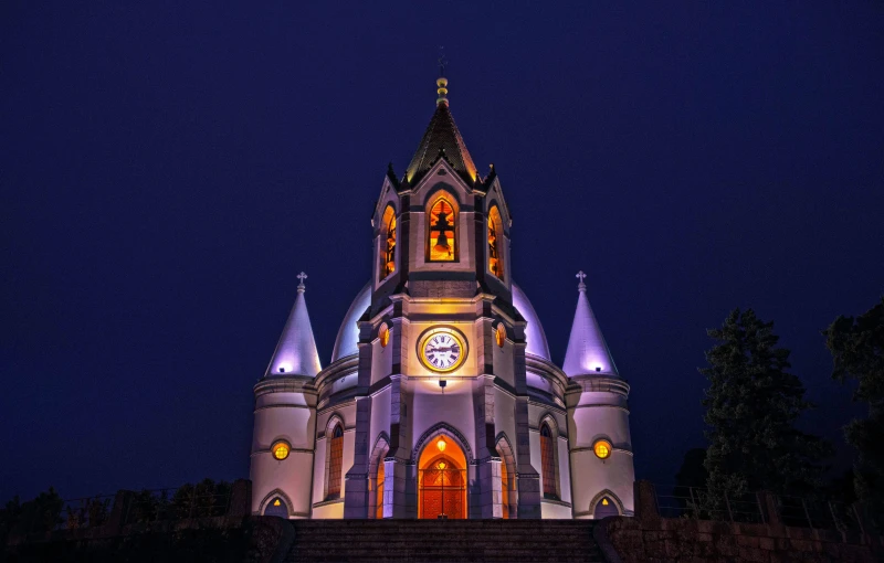 a church lit up at night with a clock, an album cover, by Julia Pishtar, unsplash contest winner, art nouveau, kalighat, domes, 2 4 mm iso 8 0 0 color, perfect symmetry