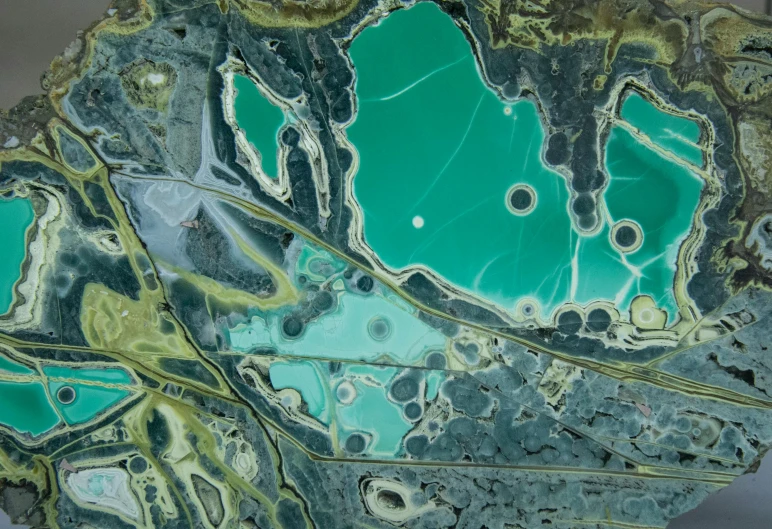 a close up of a piece of art on a table, by Lee Loughridge, unsplash contest winner, process art, satellite view, mining, teals, aussie