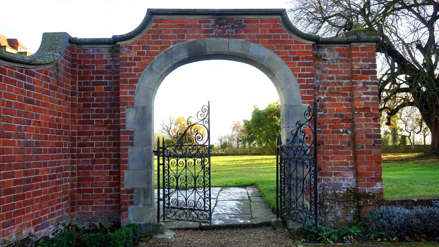 a gate in the middle of a brick wall, inspired by William Hoare, pixabay, arts and crafts movement, formal gardens, looking towards the horizon, steel archways, rococo details