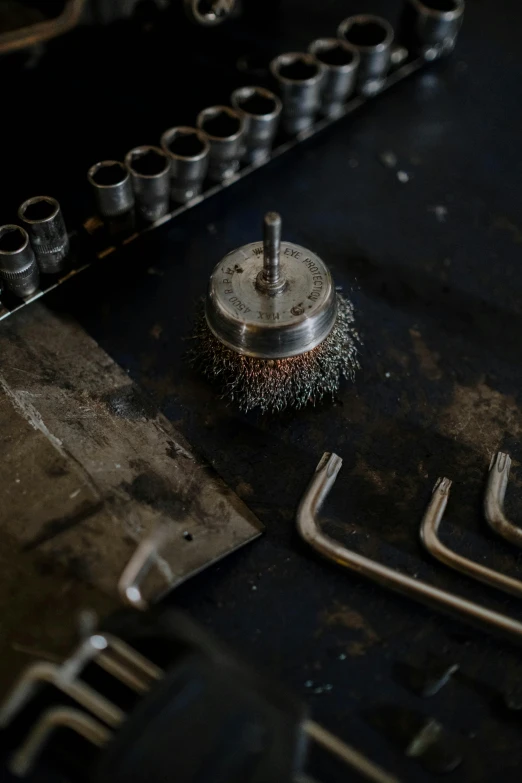 a group of tools sitting on top of a table, an album cover, unsplash, assemblage, industrial machinery, metal teeth, custom brush, steel