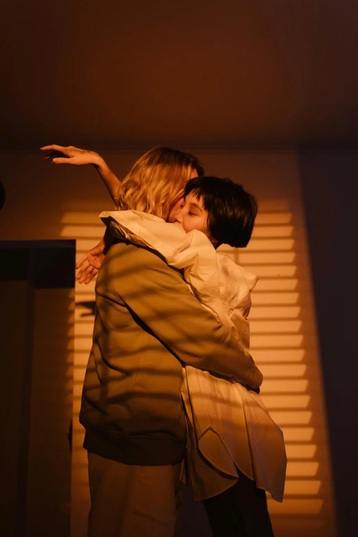 a couple of people that are hugging each other, inspired by Nan Goldin, unsplash, soft volumetric lights, lesbian, scene from live action movie, finn wolfhard