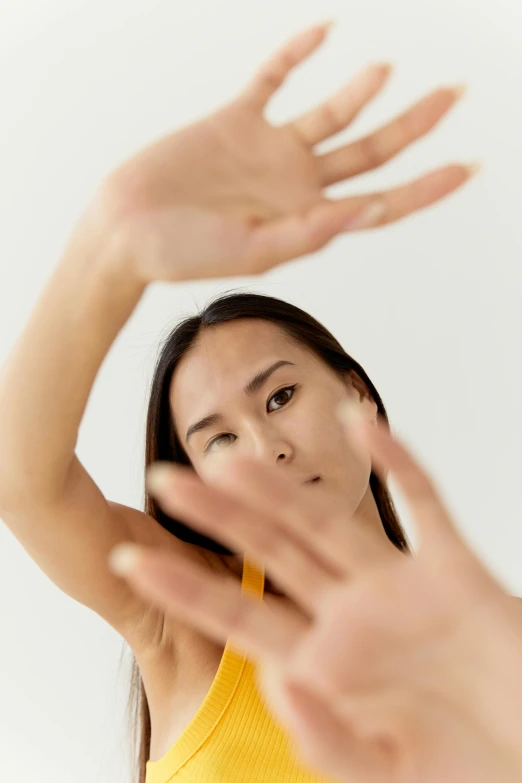 a woman making a stop sign with her hands, inspired by Fei Danxu, reflective skin, studio kai, zoomed in, choreographed