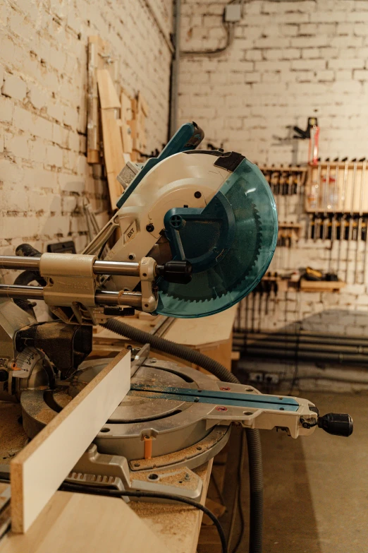 a machine that is sitting on top of a table, pexels contest winner, arbeitsrat für kunst, holding wood saw, white and teal metallic accents, weapon shop interior, 2000s photo