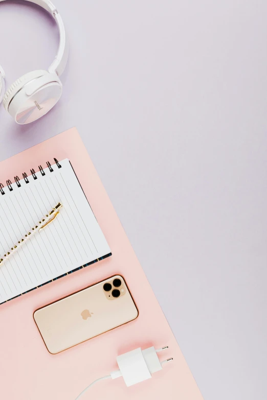 a pink notebook with headphones on top of it, trending on pexels, happening, gold and purple, professional iphone photo, minimalist desk, lilac