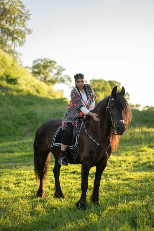 a woman riding on the back of a brown horse, a portrait, unsplash, baroque, on a green hill, wearing an elegant tribal outfit, a handsome, pr shoot