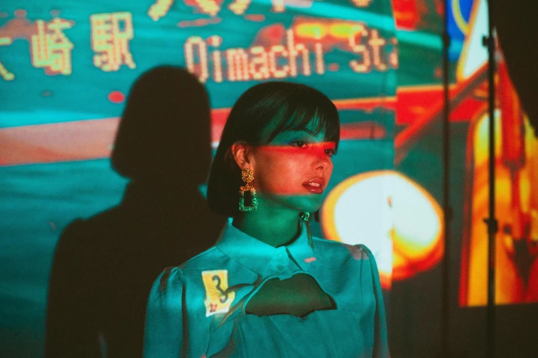 a woman standing in front of a large screen, an album cover, by Shinoda Toko, unsplash, night life, guccimaze, cinematic outfit photo, cover photo portrait of du juan