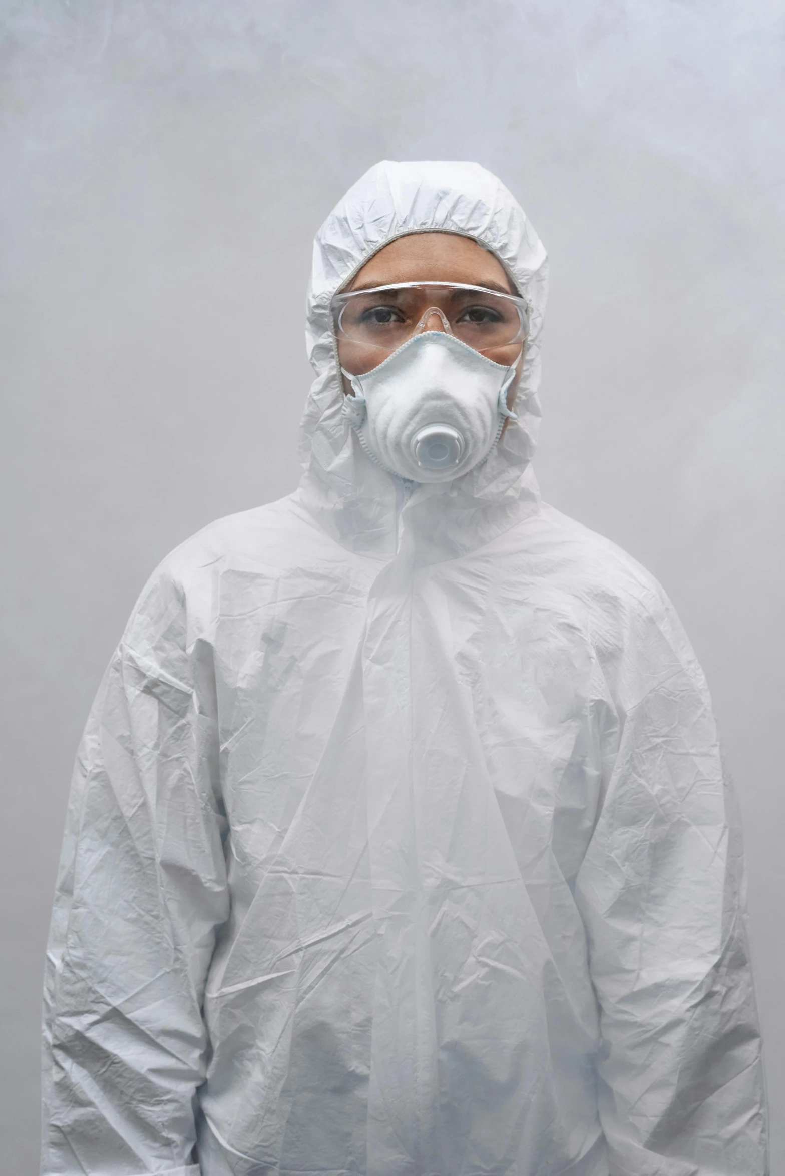 a man wearing a protective suit and goggles, inspired by Slava Raškaj, wearing a white hospital gown, in front of white back drop, ultra realism, taken in 2 0 2 0