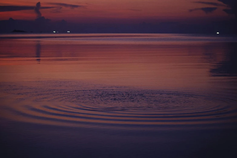 a large body of water with a sunset in the background, pexels contest winner, minimalism, swirly liquid ripples, nighttime, lo fi, ignant