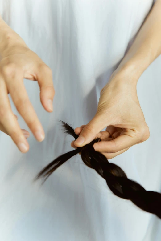 a woman cutting her hair with a pair of scissors, by Nina Hamnett, process art, braided hair loops, close-up of thin soft hand, long braided black hair, instructions