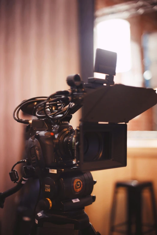 a close up of a camera on a tripod, unsplash, video art, theatre equipment, tv still, indoor shot, tv footage