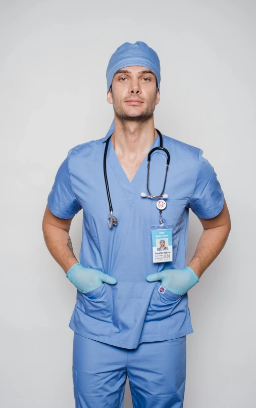 a man in scrubs standing with his hands on his hips, by Carlo Martini, pexels, david gandy, 15081959 21121991 01012000 4k, blue gloves, nurse costume