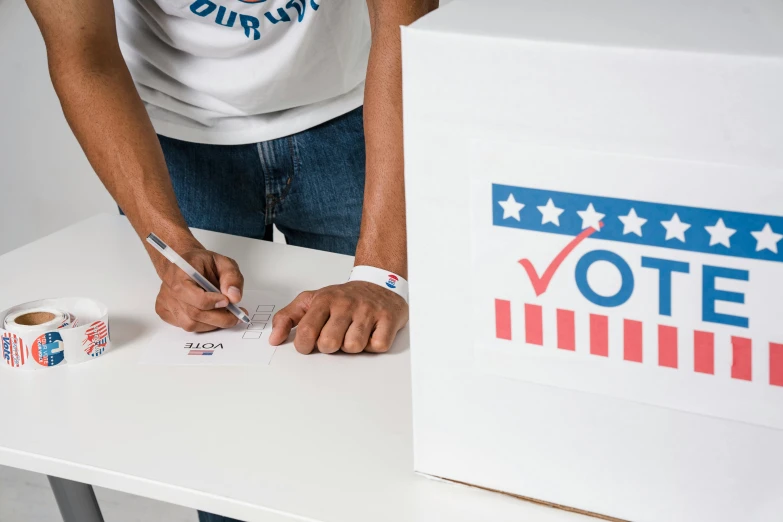 a person cutting a piece of paper with a pair of scissors, election poster, red and blue garments, thumbnail, standing on a desk