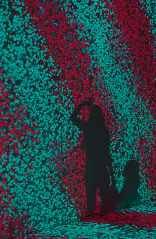 a couple of people that are standing in a room, a pointillism painting, inspired by Elsa Bleda, unsplash contest winner, interactive art, red and teal color scheme, projection design installation, teamlab, female ascending into the sky