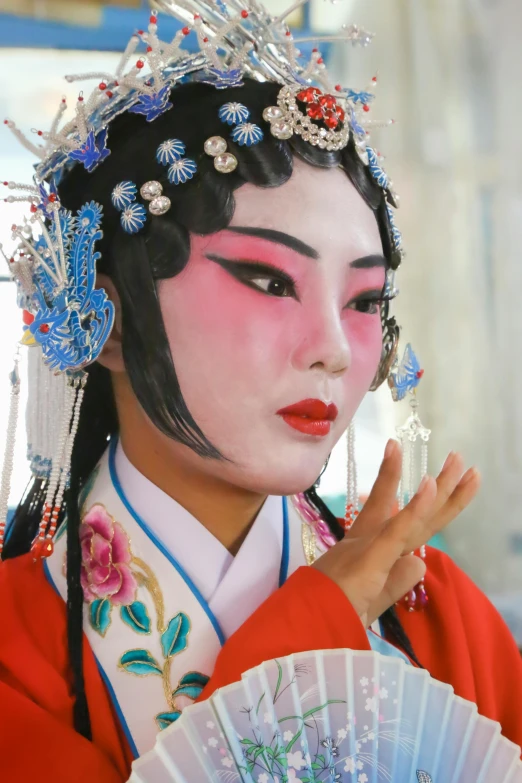 a woman dressed as a geisha holding a fan, inspired by Xie Huan, cloisonnism, markings on her face, singing at a opera house, zhuoxin ye, slide show