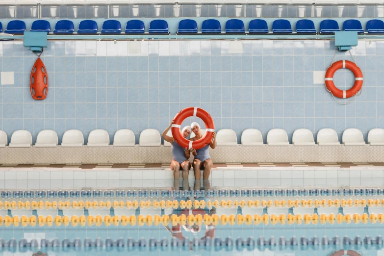 two people sitting on the edge of a swimming pool, by Nathalie Rattner, unsplash contest winner, dingy gym, pool tubes, lane brown, lachlan bailey
