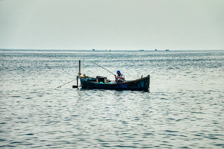 a couple of people that are in a boat in the water, by Carey Morris, pexels contest winner, fishing village, deep blue sea color, graphic print, grey