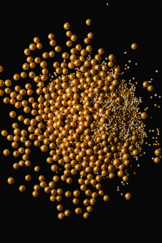 a bunch of gold balls on a black background, reddit, kinetic pointillism, silver nitrate photography, 64x64, gold and pearls, mustard