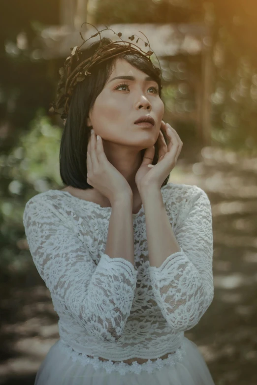 a woman in a white dress with a crown on her head, inspired by Elsa Bleda, pexels contest winner, beautiful young asian woman, dressed in a lacy, white sleeves, woman with black hair