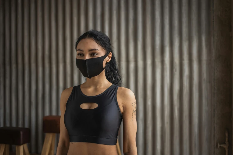 a woman in a black top and a black mask, trending on pexels, wearing fitness gear, south east asian with round face, no - text no - logo, foreground background