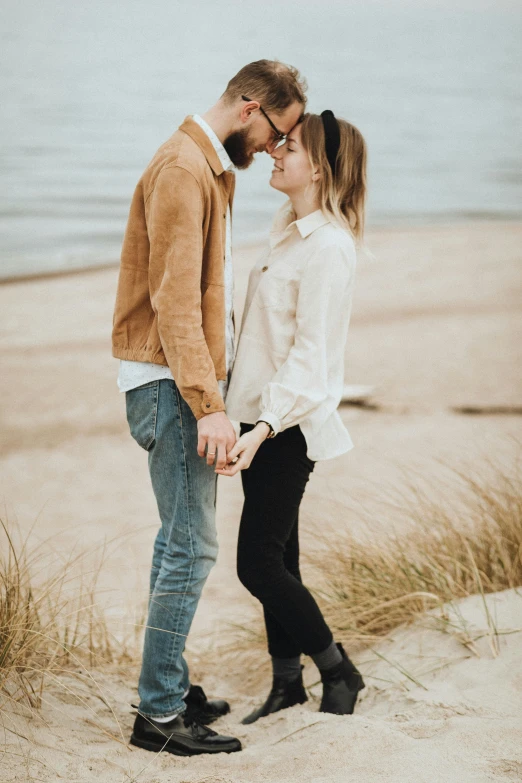 a man and woman standing next to each other on a beach, a photo, by Arabella Rankin, trending on pexels, renaissance, cute details, flirting, autumn season, 15081959 21121991 01012000 4k