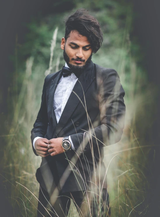a man in a tuxedo standing in tall grass, pexels contest winner, indian super model, avatar image, profile image, khyzyl saleem
