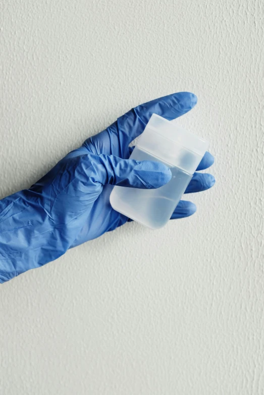 a person in a blue glove holding a plastic cup, broken leaking cell wall, made of lab tissue, subtle detailing, detailed product image