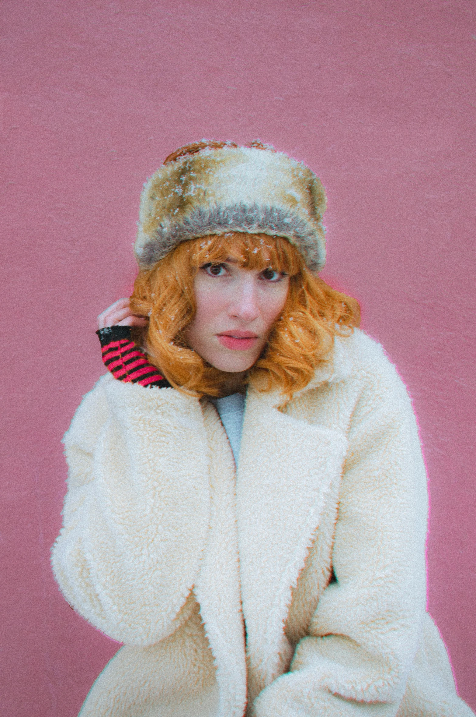 a woman with red hair wearing a white coat, an album cover, inspired by Gee Vaucher, wearing red fur, breton cap, looking straight to camera, max dennison