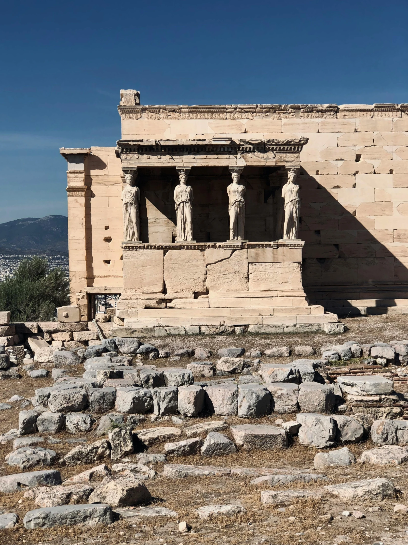 a stone building with statues on top of it, pexels contest winner, at ancinet agora of athens, ground-level view, panels, panorama