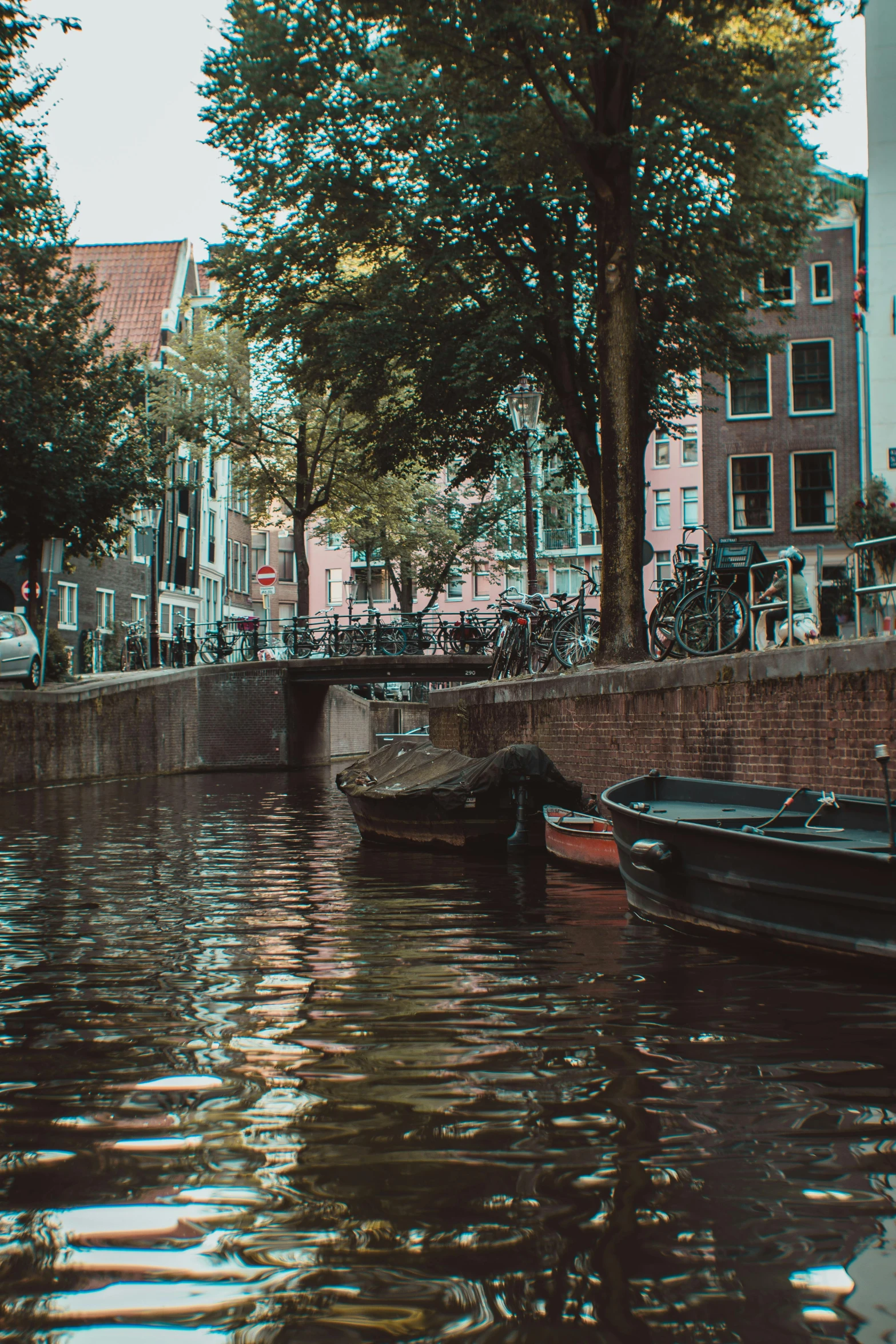 a couple of boats floating on top of a river, by Jan Tengnagel, pexels contest winner, vhs footage of a movie set, shady alleys, dutch masters, trending on vsco