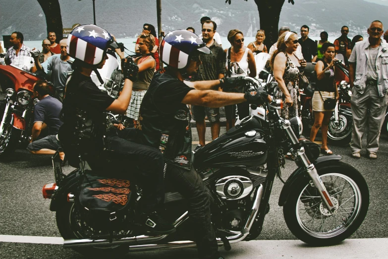 a man riding on the back of a motorcycle down a street, pexels contest winner, les automatistes, fourth of july, a group of people, avatar image