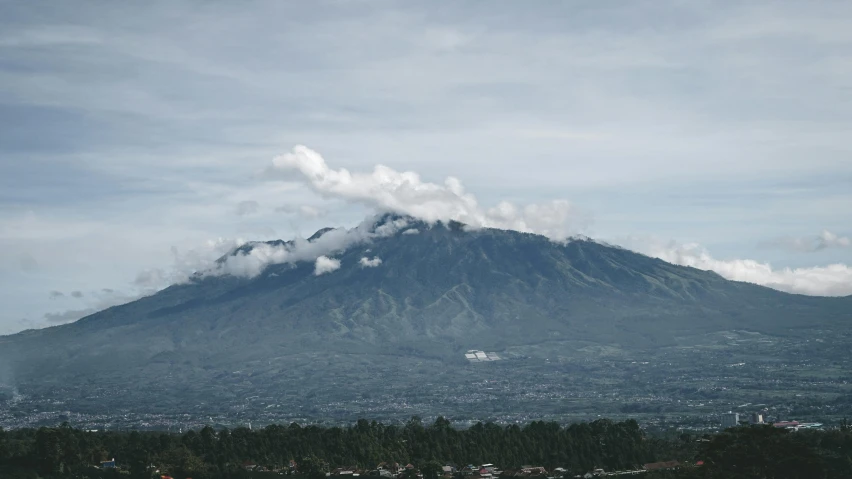 a view of a mountain with clouds in the sky, pexels contest winner, sumatraism, background image, south jakarta, zoomed in shots, view from a distance