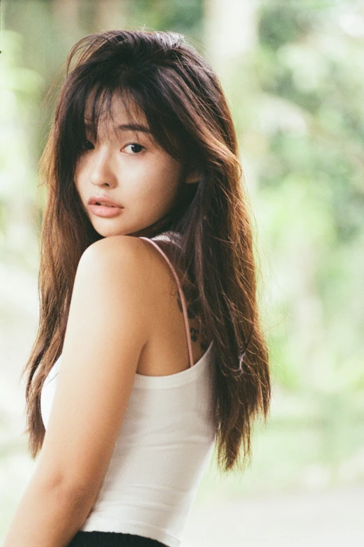 a woman in a white tank top and black shorts, an album cover, inspired by Miwa Komatsu, pexels contest winner, headshot photoshoot, ulzzang, malaysian, hair : long brown